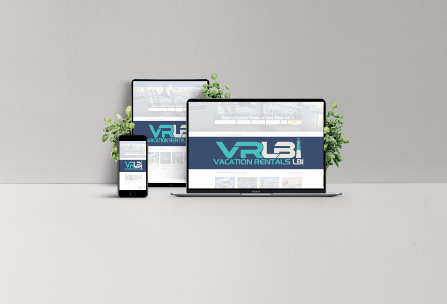 Multiple devices displaying the VRLBI Vacation Rentals LBI website, showcasing a digital marketing strategy for real estate and rental properties, with greenery in the background.